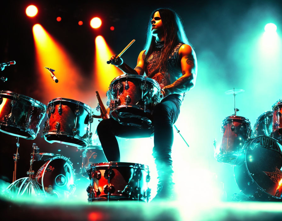 Tattooed drummer on stage under red and blue lighting