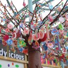 Colorful Pom-Pom Tree Against Cloudy Sky Background