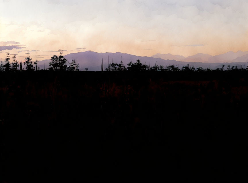 Silhouette of trees and mountains against pastel dusk sky