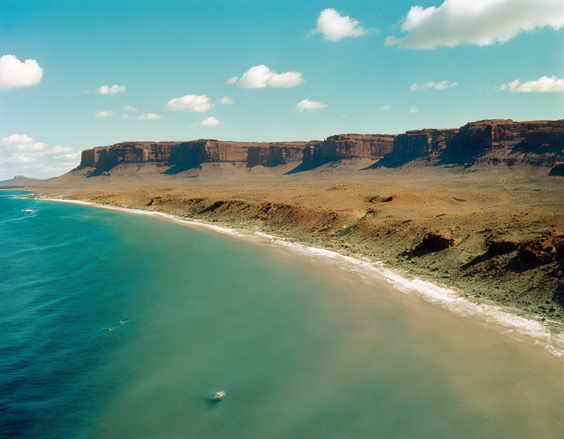 Coastline with Boat, Desert Cliffs, and Blue Sky