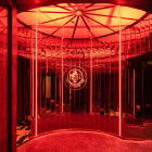 Opulent corridor with red velvet curtains and golden walls