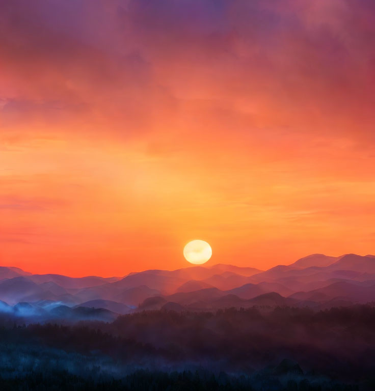 Colorful sunset over mountain silhouettes with purple-orange clouds.