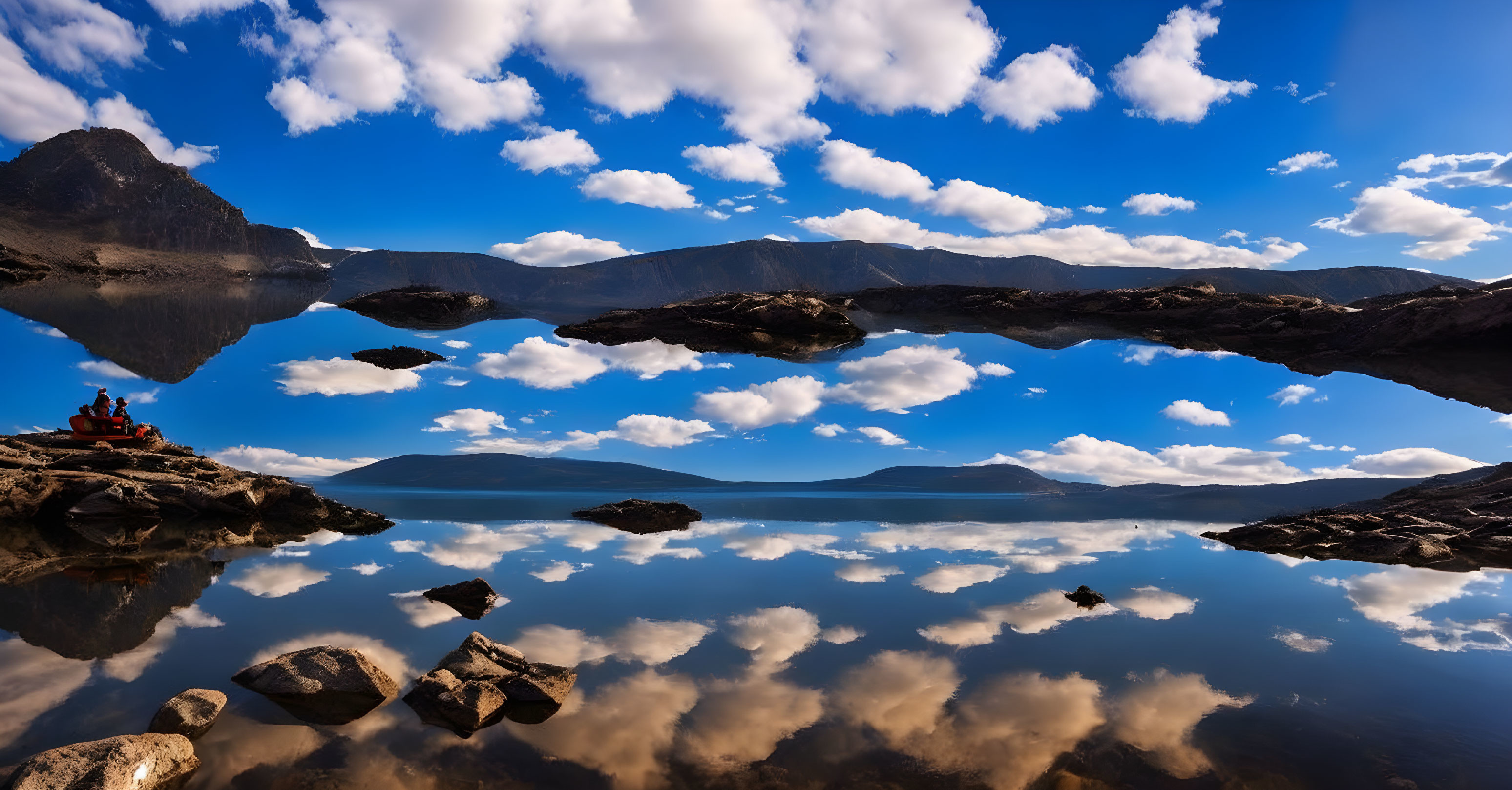 Tranquil mountain scene with clear lake and people admiring view