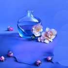 Transparent vase with floral patterns on reflective surface, white flowers and buds, blue background