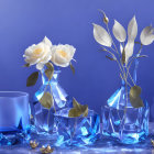 Three crystal vases with white roses on blue background, scattered petals and glass dishes