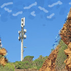 Red Rock Spires Amid Green Landscape Under Blue Sky