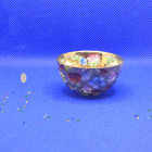 Intricate Golden Cup on Blue Background with Floral Designs