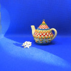 Teapots and Jewelry on Blue Marbled Surface