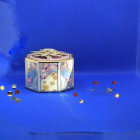 Golden-patterned magical box with pink roses and floating petals on starry blue background