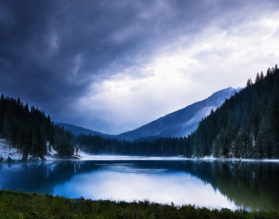 Mountain lake reflection under stormy sky with evergreen forests - serene scene.