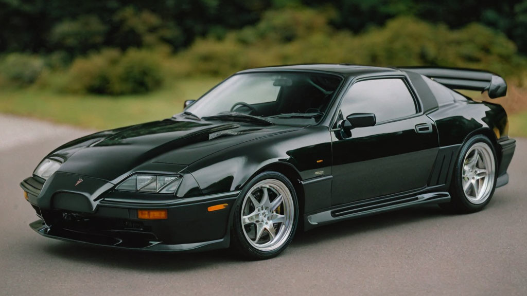 Sleek Black Sports Car with Pop-Up Headlights and Rear Spoiler