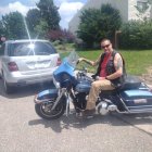 Group of Motorcyclists Riding on Sunny Day with Woman on Blue Cruiser Bike