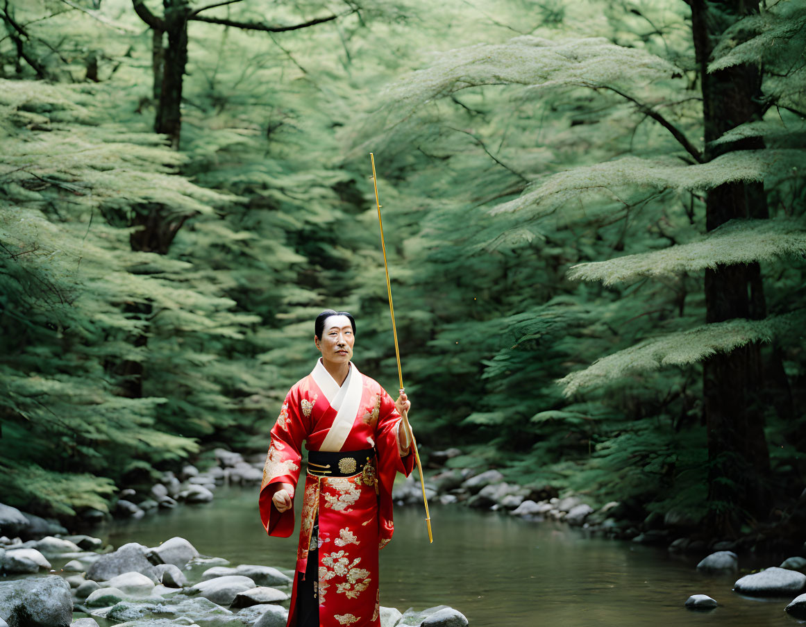 Person in red traditional attire with bow in serene forest setting