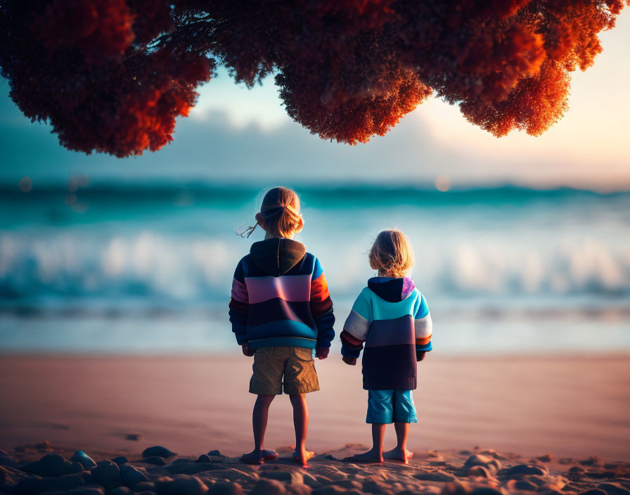 Children under tree gazing at sea during sunset