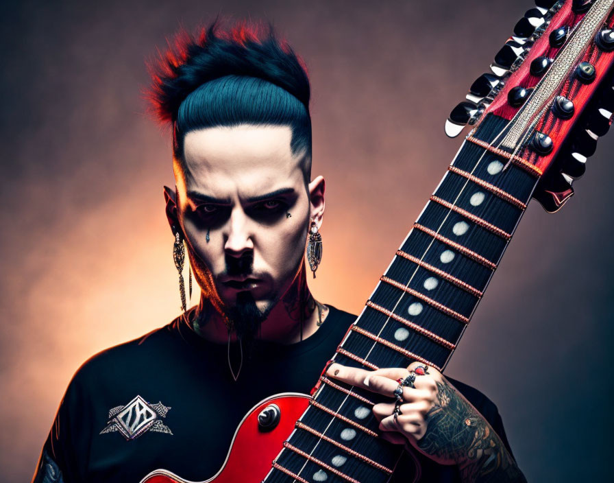 Person with Mohawk and Tattoos Holding Red Electric Guitar on Dramatic Colored Background