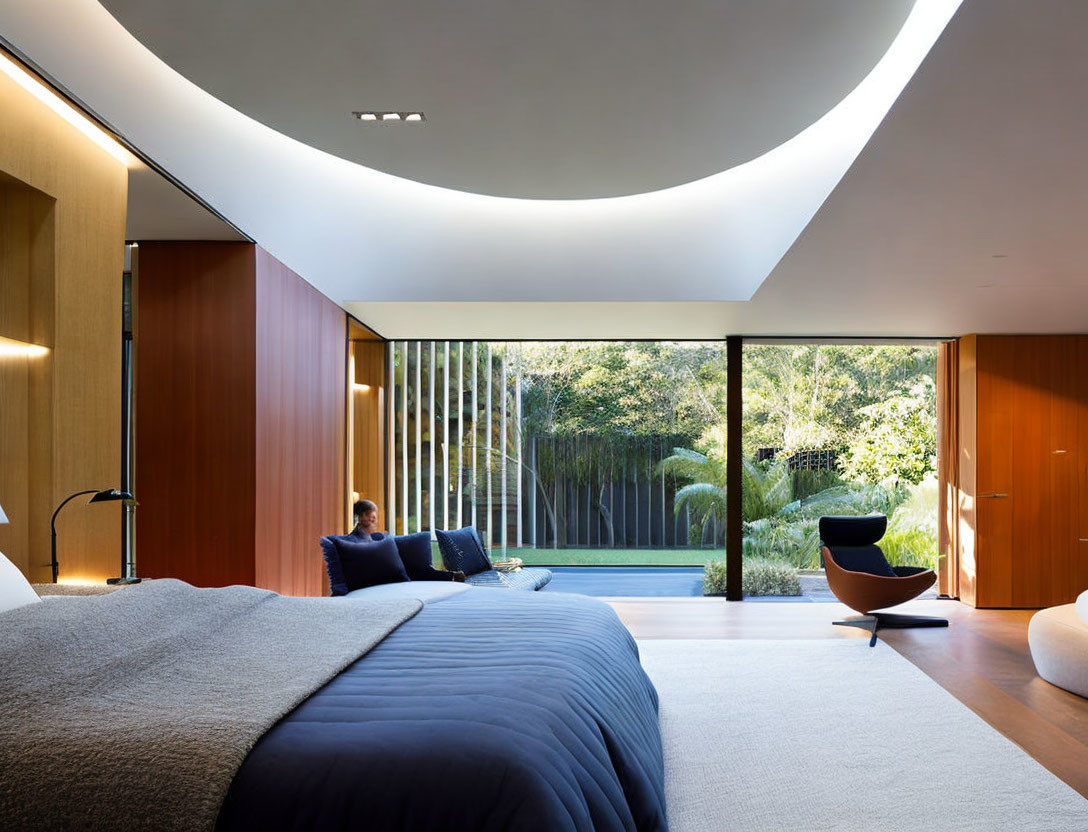 Spacious modern bedroom with large bed, curved ceiling light, and floor-to-ceiling windows.