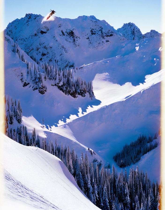 Snowy Mountain Landscape: Helicopter Soaring Over Peaks and Valleys