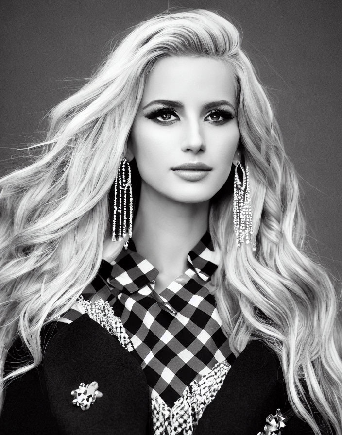 Monochrome portrait of woman with long blonde hair and chandelier earrings