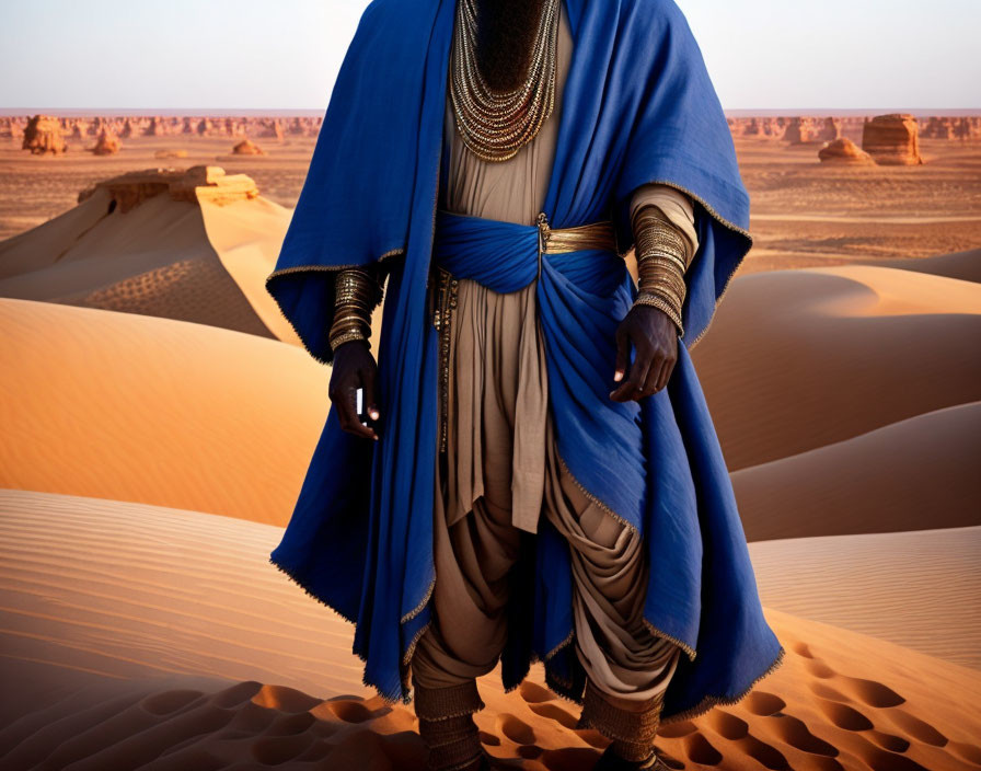 Tuareg person in blue robes and silver jewelry in desert setting