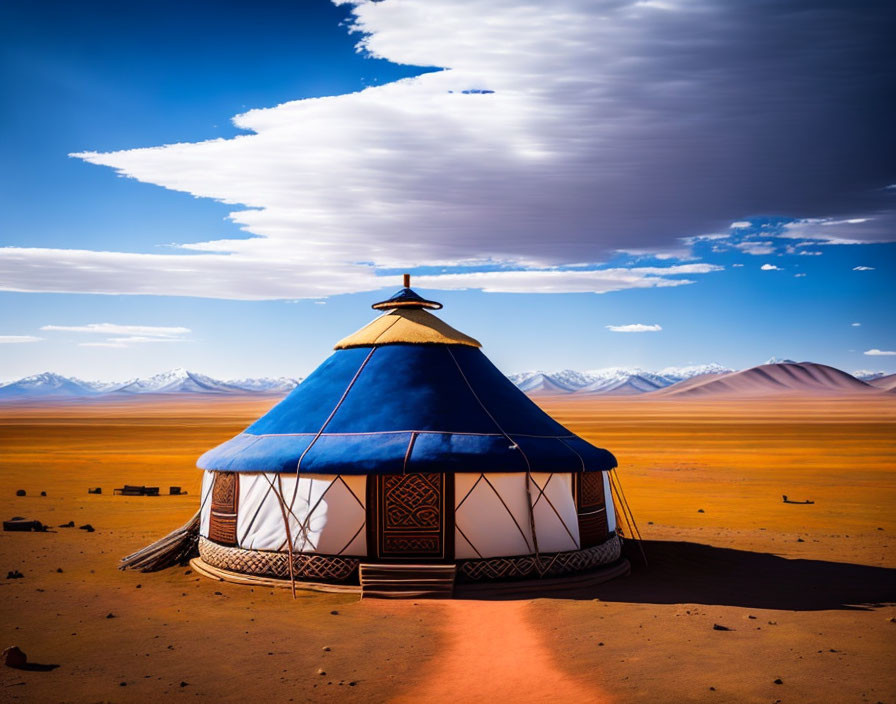 Traditional yurt with blue roof in vast desert landscape