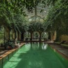 Indoor Pool Surrounded by Greenery and Glass Ceiling