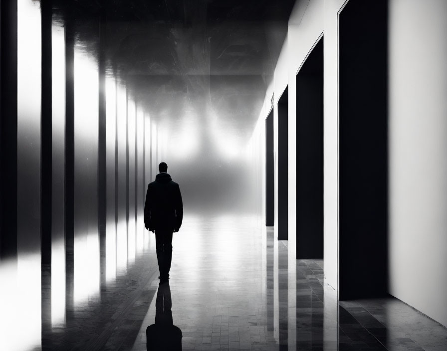 Solitary figure in high-contrast hallway with dramatic lighting