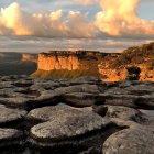 Vibrant blue rock formations and golden spires in a serene landscape