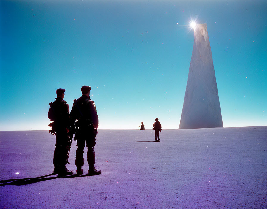 Silhouettes of Two People by Monolithic Structure on Sunlit Plain