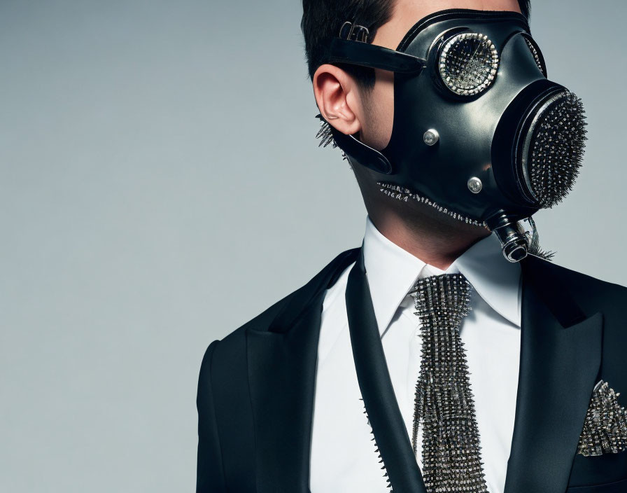 Futuristic gas mask with ornate tie and pocket square on person in suit