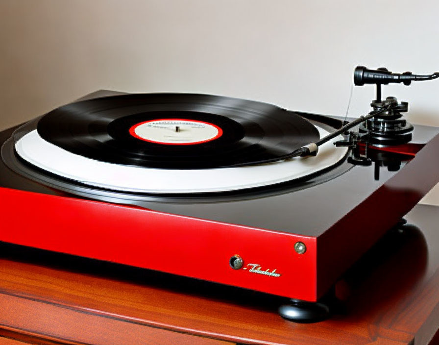 Red Turntable Playing Vinyl Record on Wooden Surface