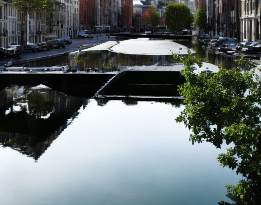 Tranquil cityscape with canal, bridge, and clear sky