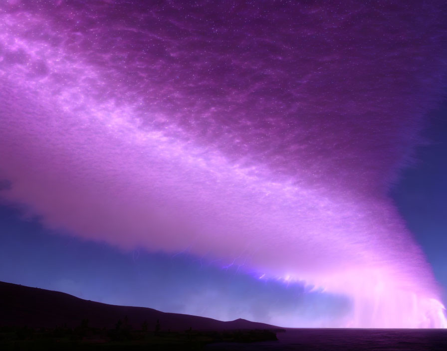 Vibrant purple aurora over tranquil ocean and hill silhouette