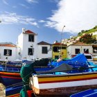 Surrealist painting of ship with house floating on calm waters