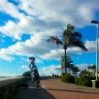 Surreal European-style buildings, tall tree, oversized sunflower under blue sky