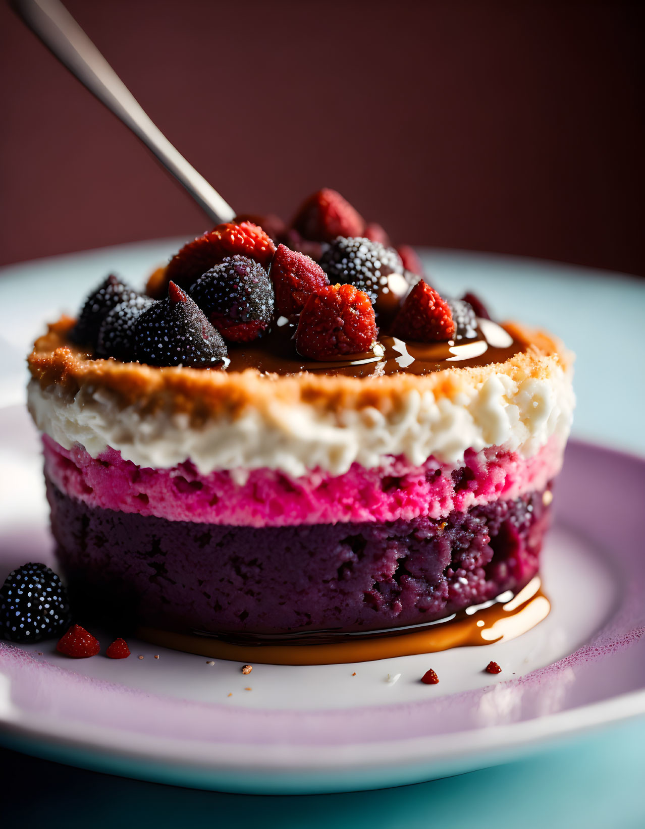 Colorful Berry Cheesecake with Creamy Layer and Fresh Berries on White Plate