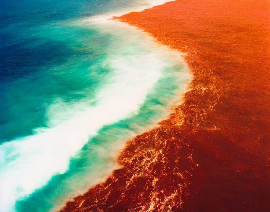 Stark Color Contrast: Deep Red Sea Meets Turquoise Ocean