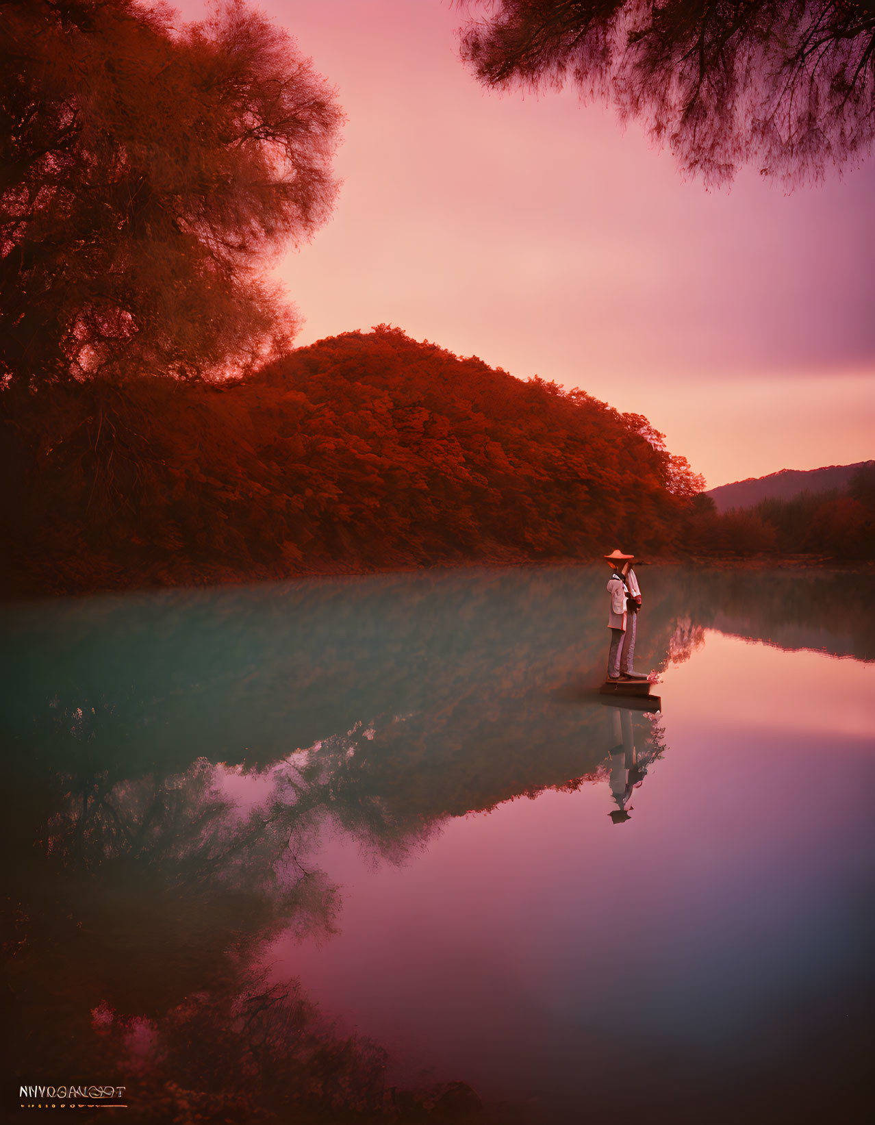 Tranquil lake with paddleboarder and red foliage reflections