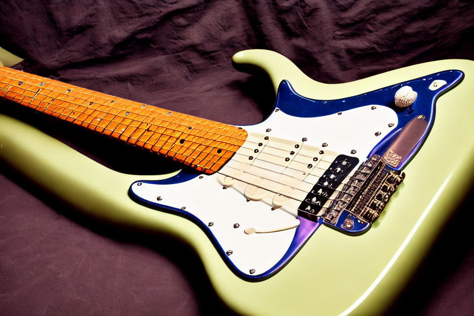 Mint Green Electric Guitar with White Pickguard on Maple Fretboard