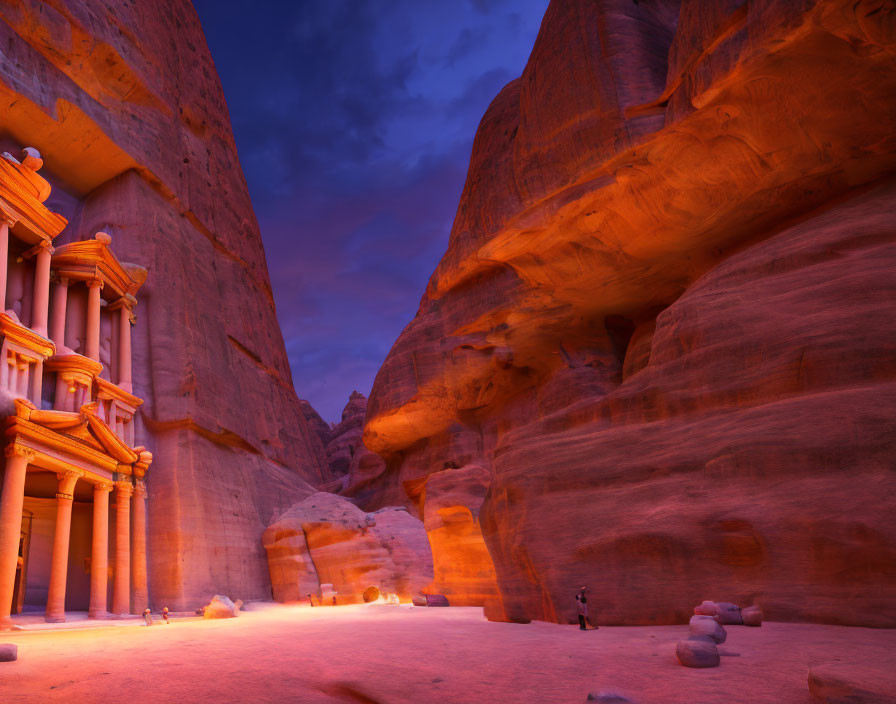 Ancient rock-cut architecture of Petra at twilight with blue sky and red stone