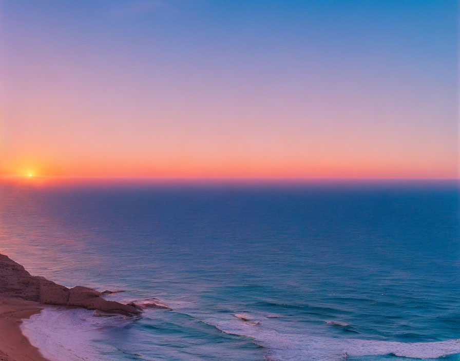 Tranquil Beach Sunset with Blue, Pink, and Orange Skies