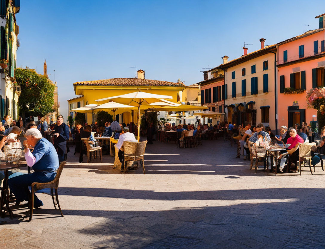 Outdoor dining scene in sunny square with colorful buildings and umbrellas