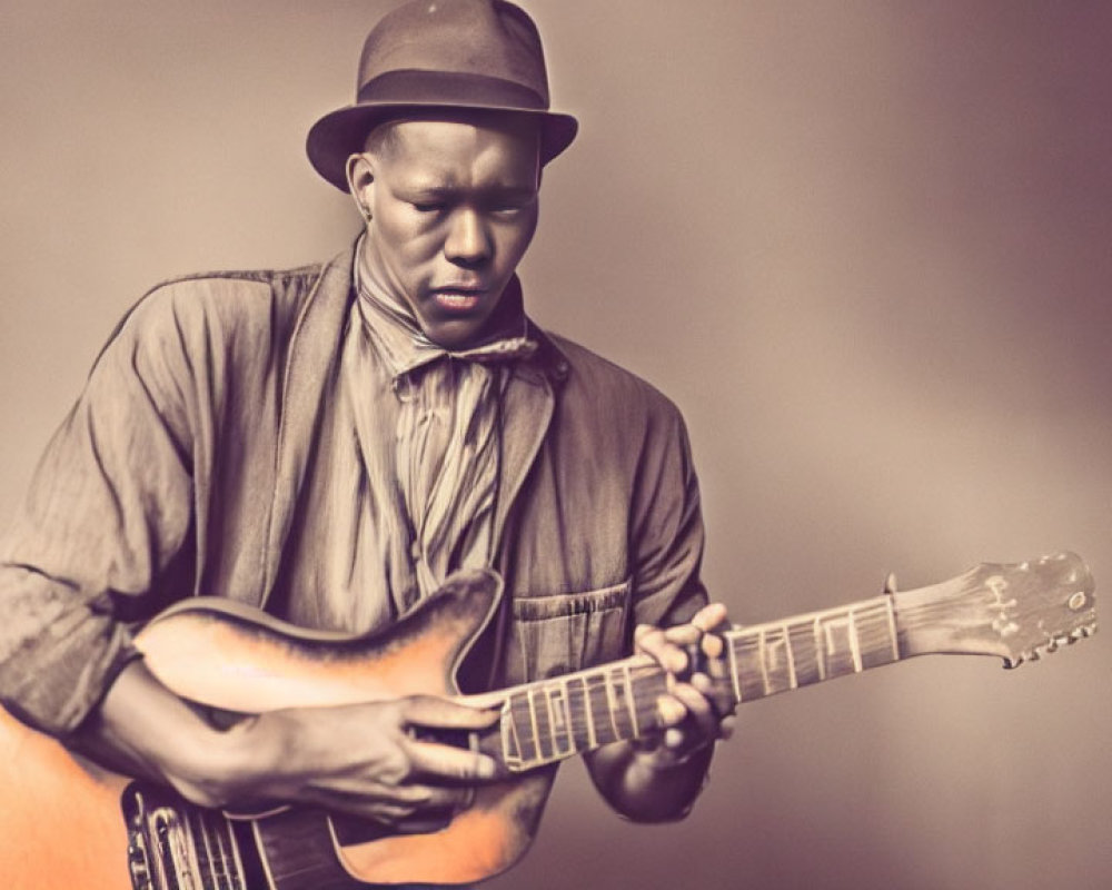 Man in fedora playing electric guitar against sepia background