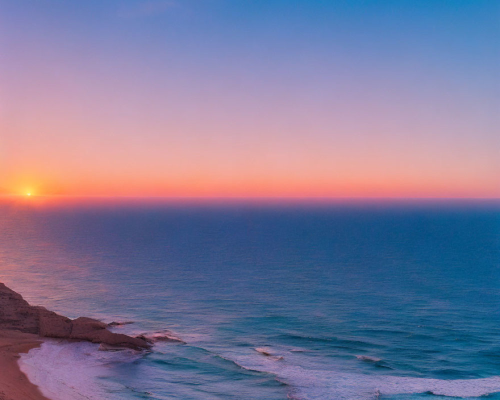 Tranquil Beach Sunset with Blue, Pink, and Orange Skies