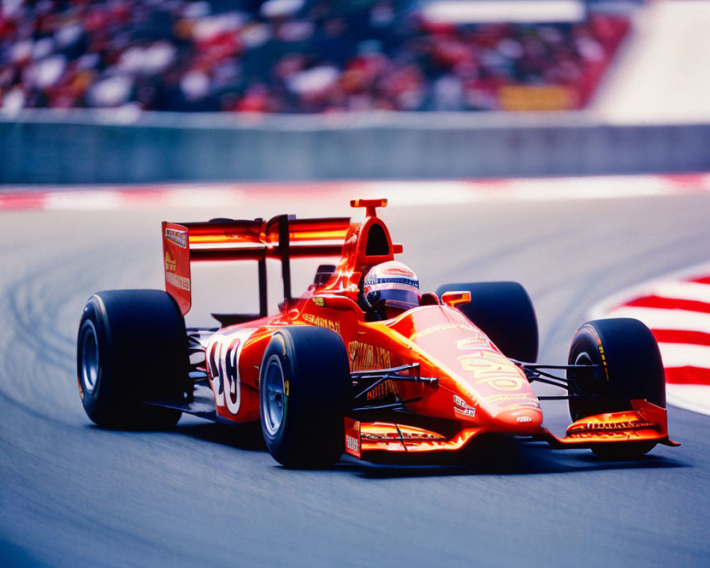 Red Formula 1 race car speeding on racetrack with blurred grandstands