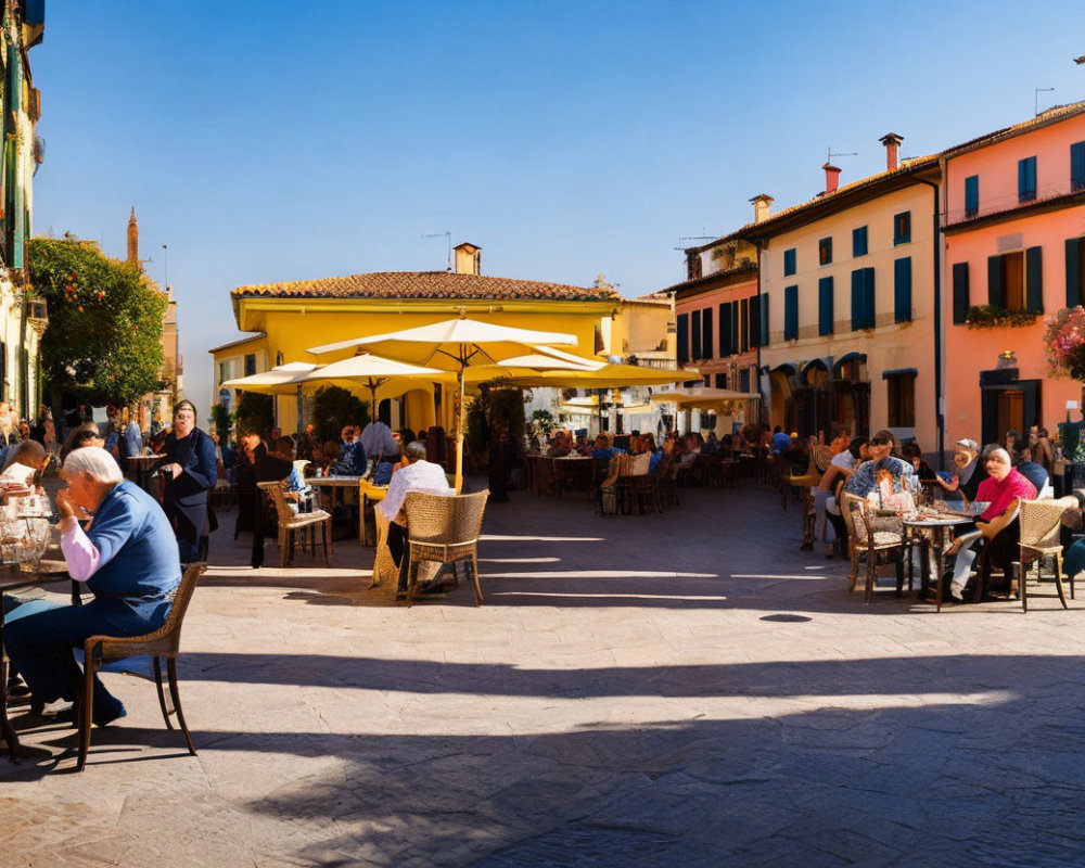 Outdoor dining scene in sunny square with colorful buildings and umbrellas