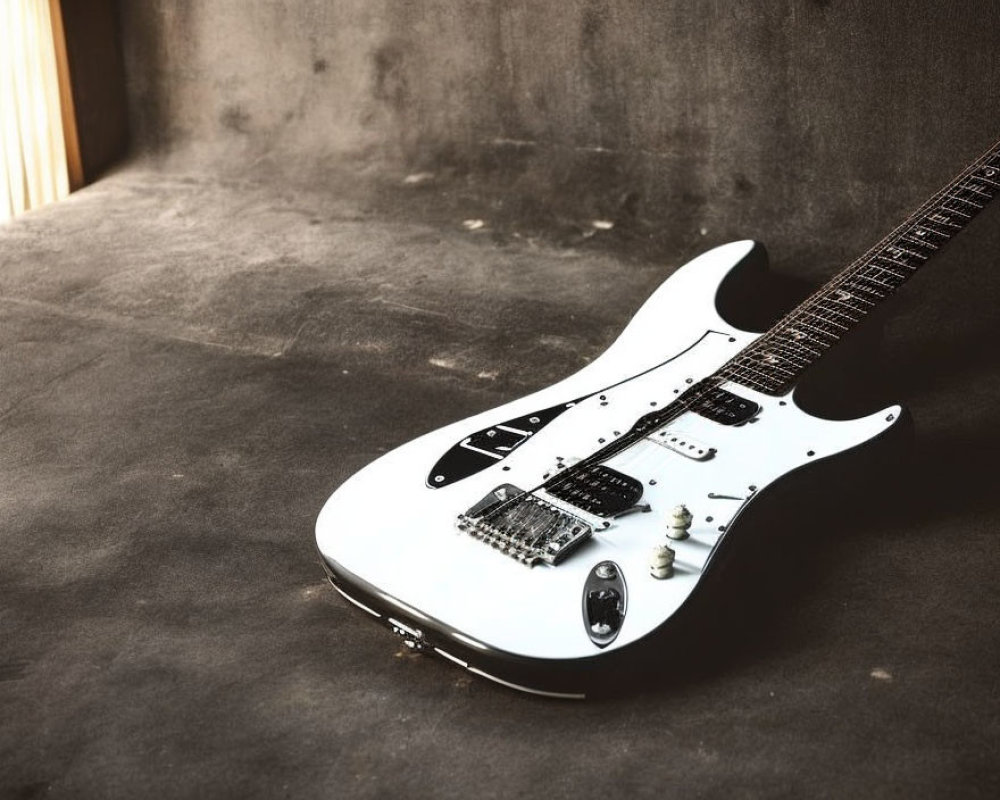 White Electric Guitar with Black Pickguard on Gritty Grey Floor