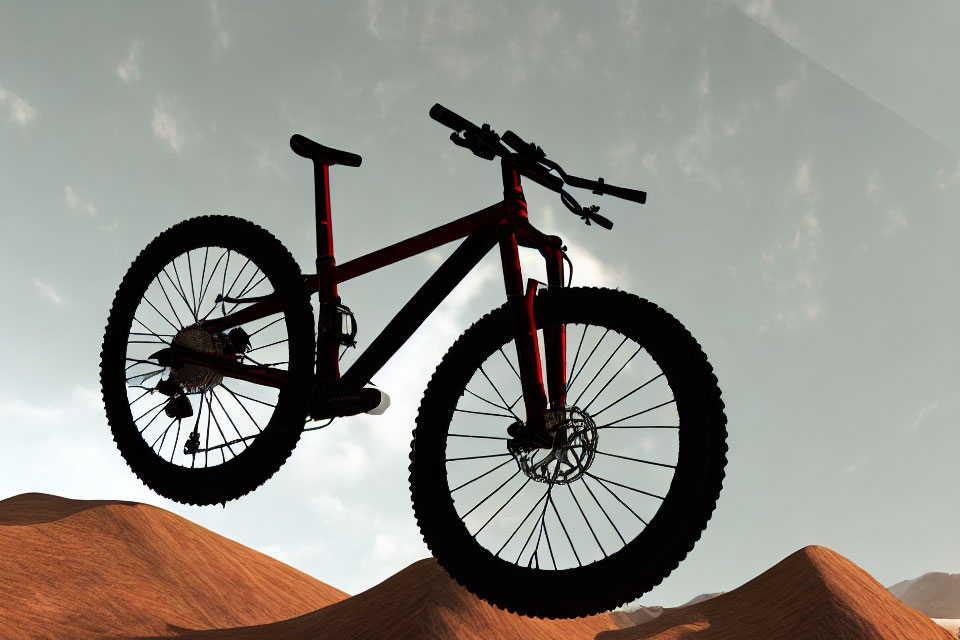 Mountain bike silhouette against warm desert sky.