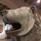 Stone lion sculpture in ornate medieval room