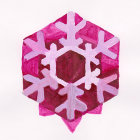 Symmetrical pink and white paper art with geometric and floral design