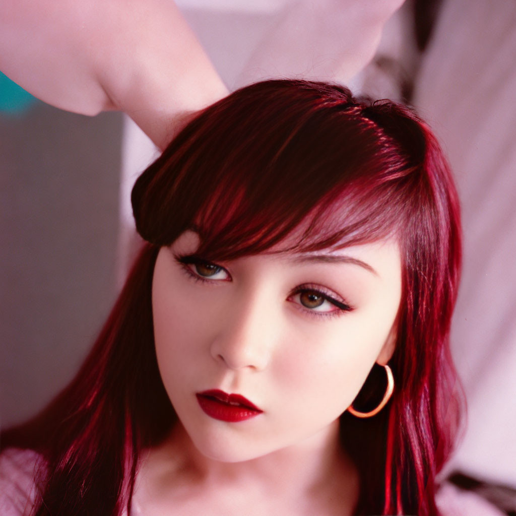 Woman with Red Hair and Hoop Earrings Posing in Close-up Shot